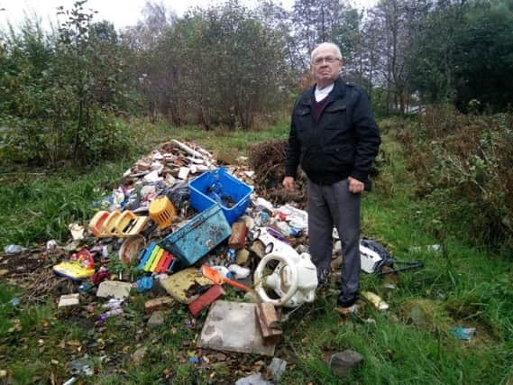 Coun George Davies with the fly-tipped rubbish