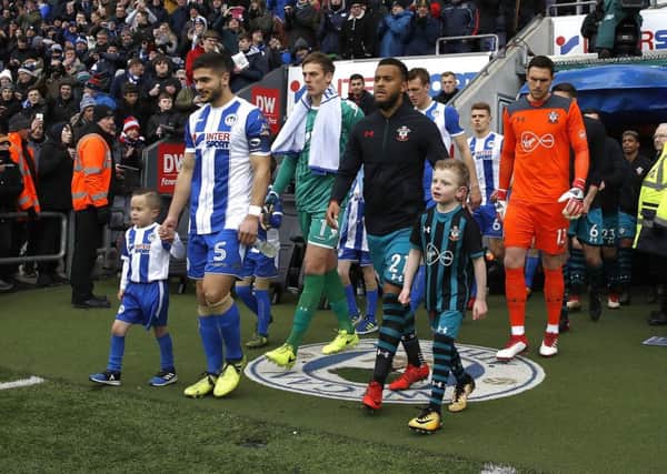 Wigan Athletic's Sam Morsy (left) and Southampton's Ryan Bertrand (right) walk out with mascots for the Emirates FA Cup, quarter final