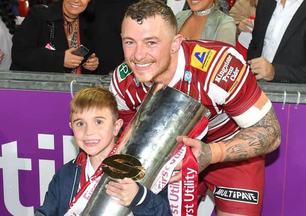 Josh Charnley with Jack Johnson, the inspiration for the Joining Jack charity, after the 2016 Grand Final win