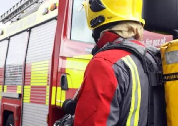 Brave firefighters rescued two people and a dog from an upstairs flat