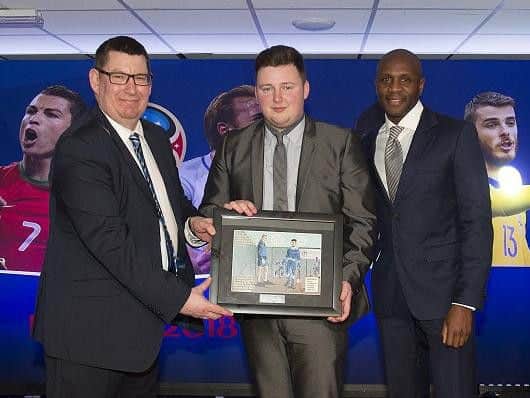 Oliver receives his comic illustration from Tom Flowers and Latics legend Emmerson Boyce