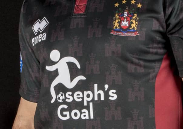 The logo on the Wigan shirt