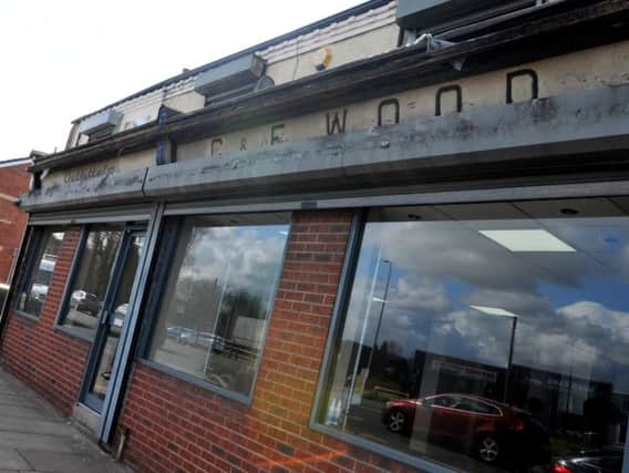 The old sign revealed by high winds at the Platt Bridge hair salon