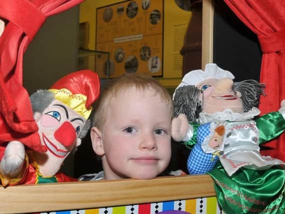 A youngster with Punch and Judy at the Museum of Wigan Life