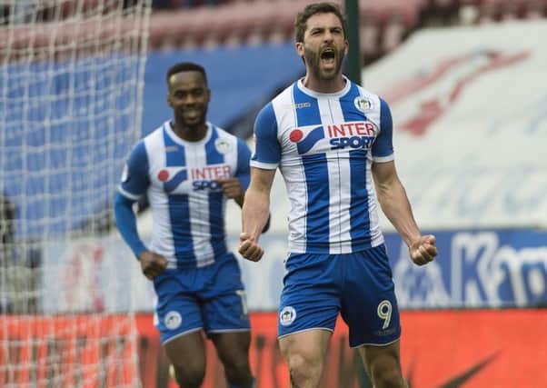 Will Grigg celebrates scoring against MK Dons
