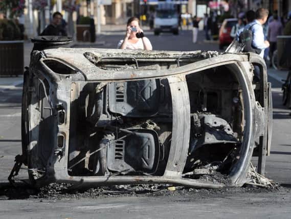 A burnt out Smart car in London
