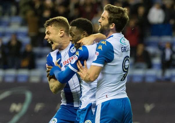 Will Grigg celebrates scoring a dramatic late winner for Wigan Athletic against Oxford