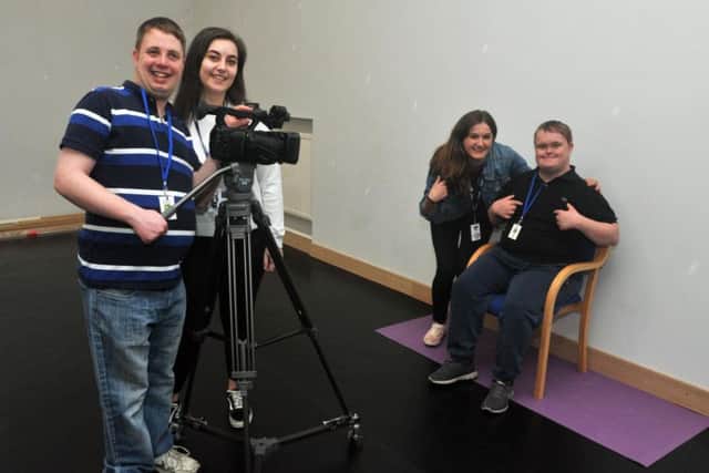 Apprentice Katie Winnard, second from left, and project leader Beth Prole, second from right, with students.
Students at One Vision, a media training centre for adults with additional needs, have been learning sign language for a new music video.
