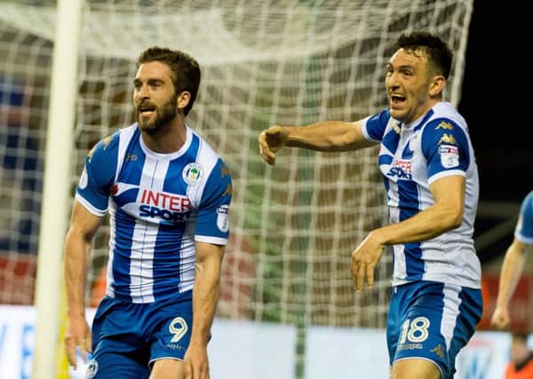 Will Grigg's goal against Oxford has put Latics on the brink of promotion