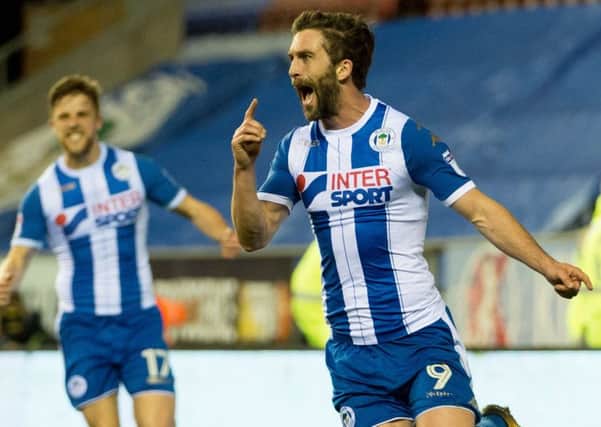 Will Grigg celebrates his goal on Tuesday