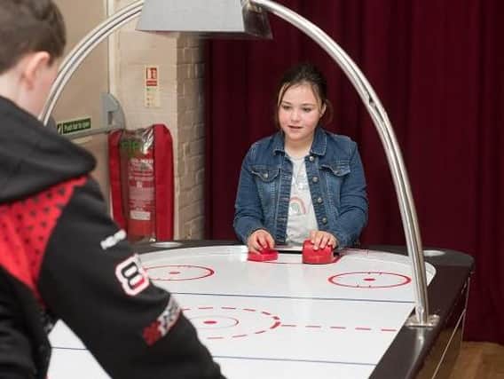 Air hockey is one of the club attractions