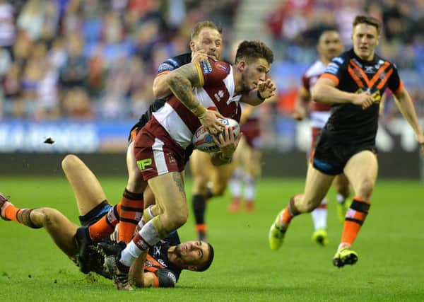 Wigan Warriors' Oliver Gildart  is tackled by Castleford Tigers' Paul McShane 

BetFred Super League match at the DW Stadium