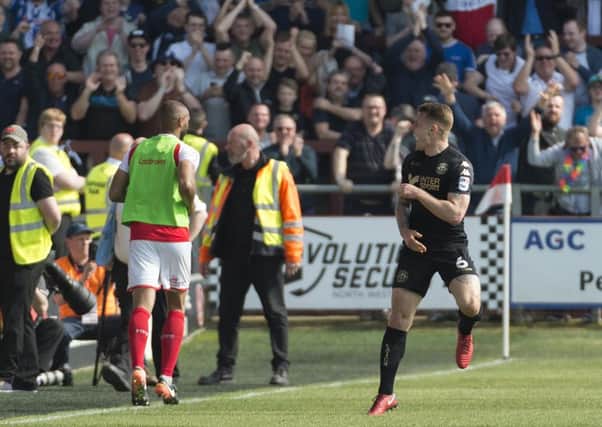 Max Power celebrates with the packed away end after netting number one