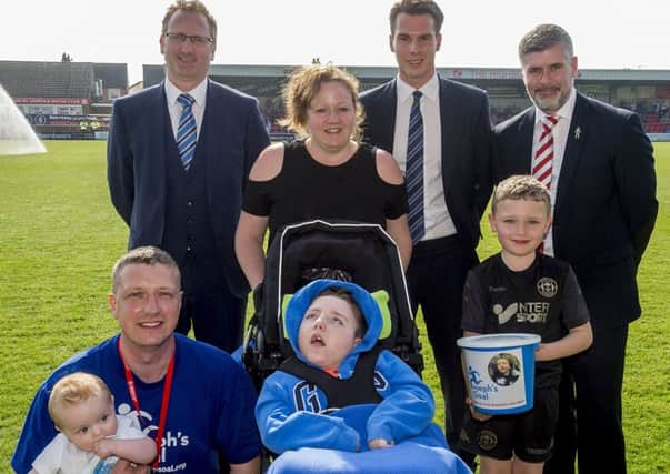 Joseph Kendrick, and family, with Latics chairman David Sharpe, chief executive Jonathan Jackson and Fleetwood CEO Steve Curwood during the half-time interval at Highbury Stadium