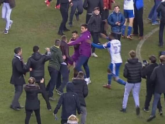 Fans invade the pitch after Latics' win over Manchester City in February