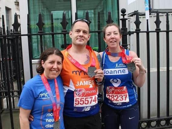 Joanne Platt, right, celebrates completing the London marathon with Julie Barton, leader of Julies Joggers, and James Pentland