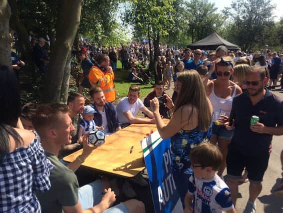 Fans mingle with the Wigan Athletic players at the party in the park