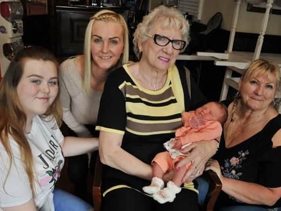 The oldest member of the family Brenda Whittle, 76, holds the youngest member her great-great-grandaughter, Evie-Jae Pye, one-week-old, centre, pictured with great-grandaughter Leah Crompton, 20, left, grandaughter Lisa Lowe, 39, and daughter Tina Brown, 57, right