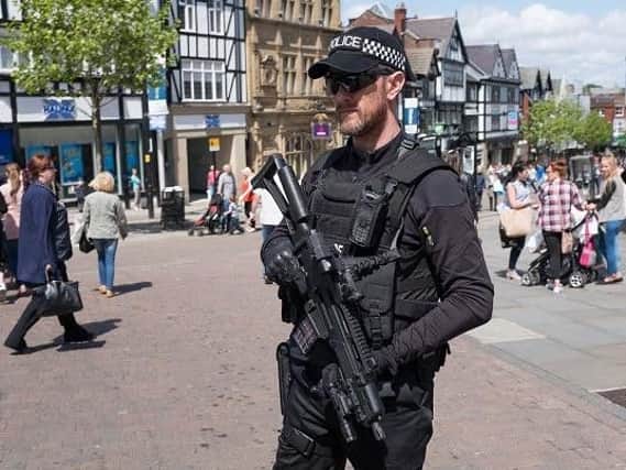 Armed police officers in Wigan town centre after the day after the Manchester Arena boming last year