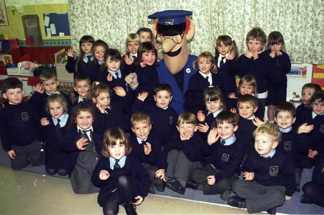 Great excitement for Downall Green schoolchildren as they receive a surprise visit from Postman Pat in 1997.