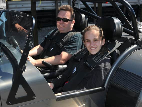 Driver Tim Pollard, left, with Abigail Bates in the passenger seat