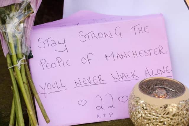 Tributes left outside St Ann's Church in Manchester, the morning after a suicide bomber killed 22 people at an Ariana Grande concert