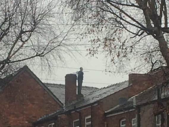 McCormick tries to evade capture by climbing onto his roof