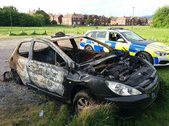 The abandoned car which has now been smashed up and torched