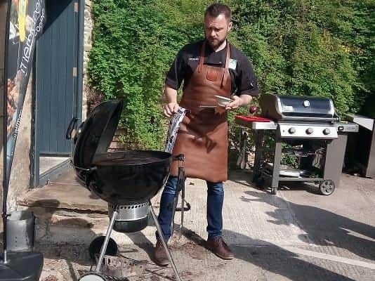 Richard prepares the BBQ for cooking