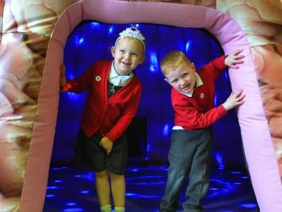 Pupils Isla and Jack, both three, emerge from the inflatable brain